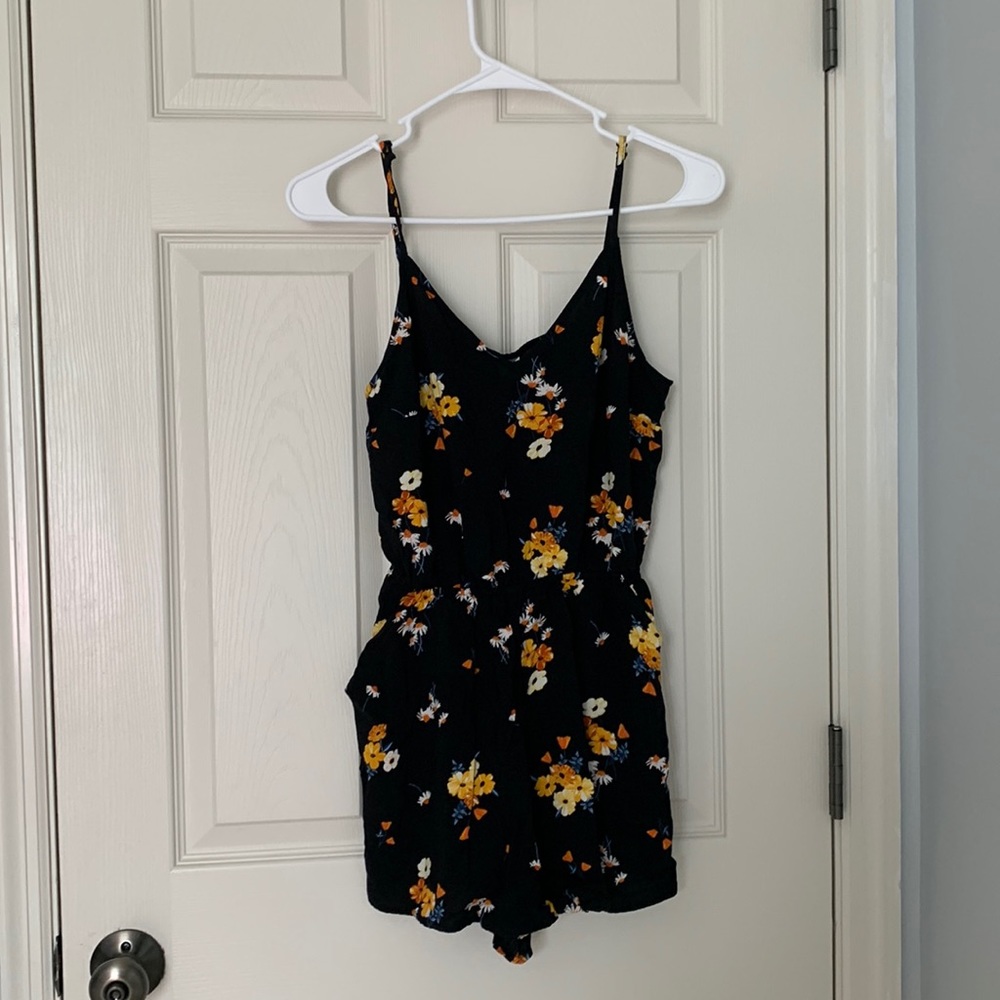 Divided Black and floral romper with pockets.